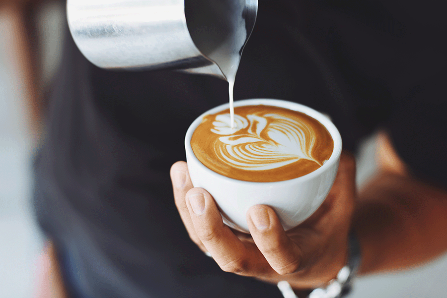Close-up of barista pouring coffee